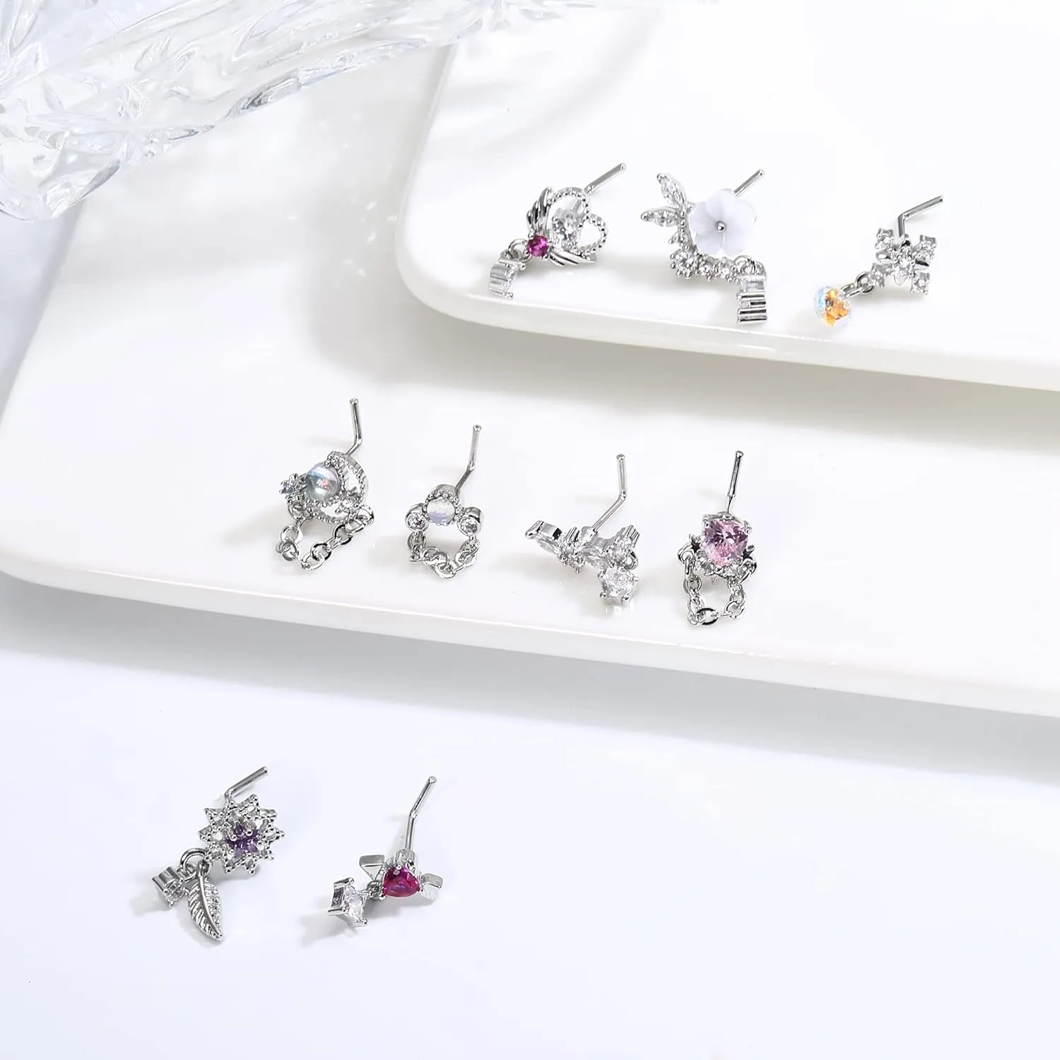 JOERICA 9 Pcs 20G Dangle Nose Rings Studs for Women Stainless Steel L Shaped Nose Studs Heart Arrow Feather Snowflake Wing CZ Dangling Nose Piercing Jewelry